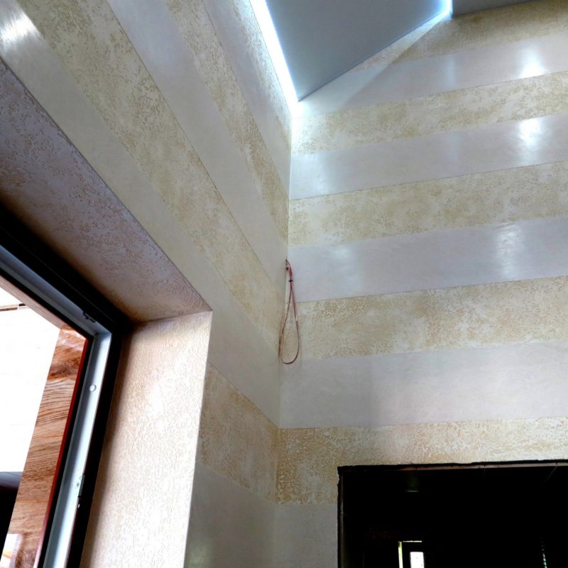Textured travertine base and marmorine strips